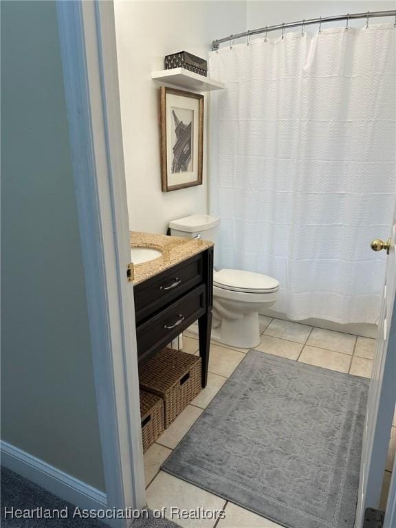 bathroom with tile patterned floors, vanity, and toilet