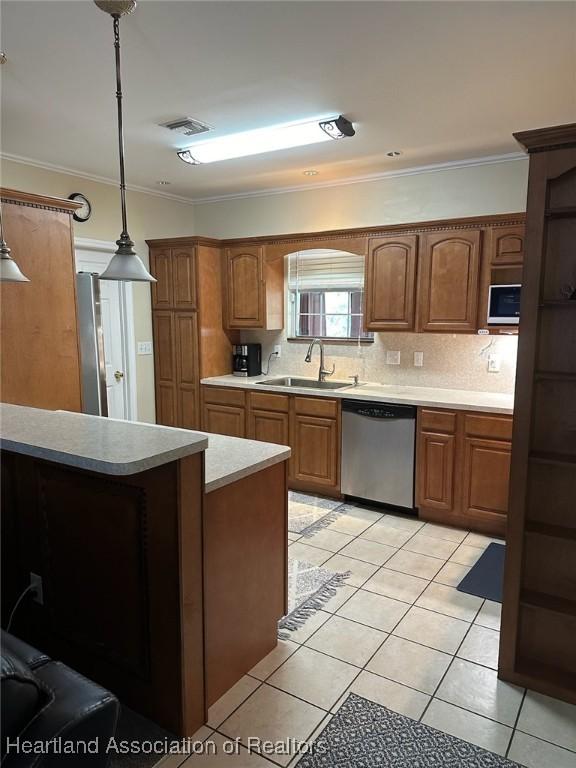 kitchen with dishwasher, sink, hanging light fixtures, tasteful backsplash, and light tile patterned flooring