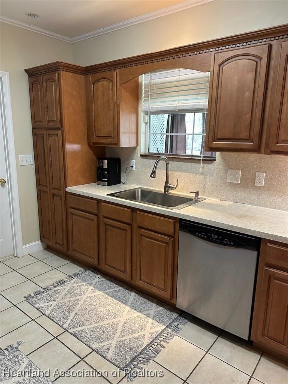 kitchen with dishwasher, sink, backsplash, crown molding, and light tile patterned floors