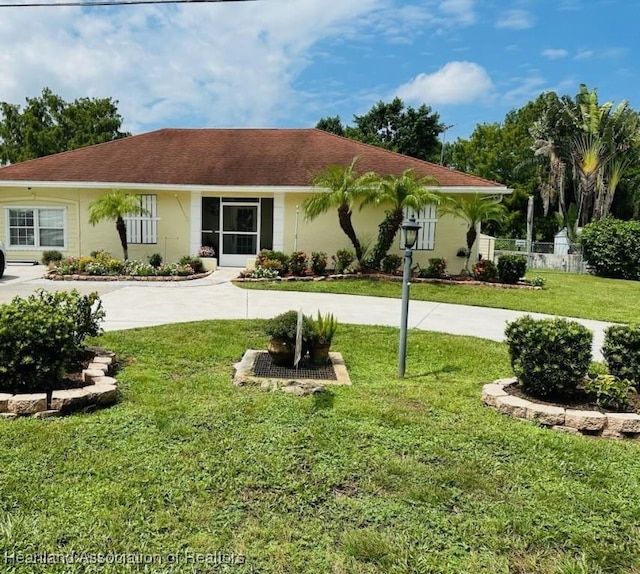 ranch-style home with a front lawn