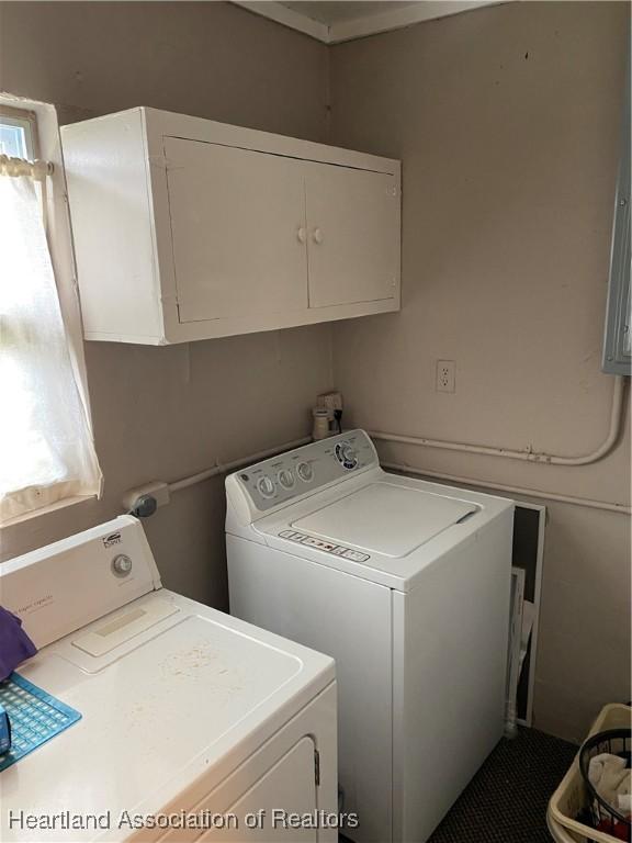 washroom with cabinet space and washer and clothes dryer