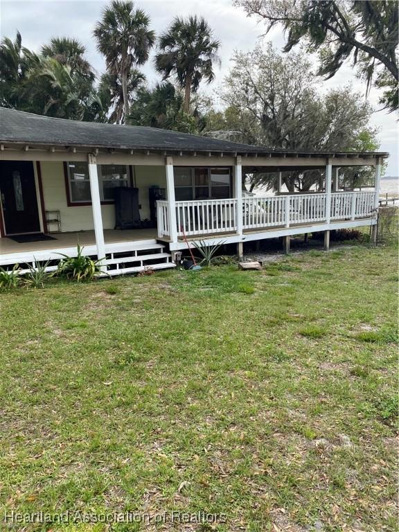 rear view of house featuring a yard