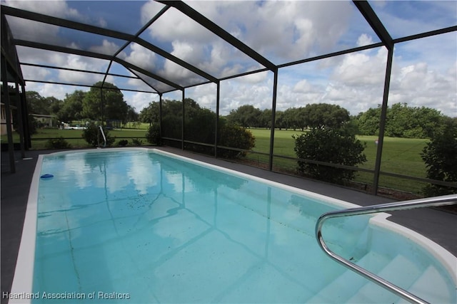 view of pool featuring glass enclosure