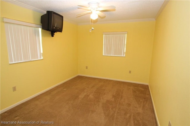 carpeted spare room featuring a textured ceiling, ceiling fan, and ornamental molding