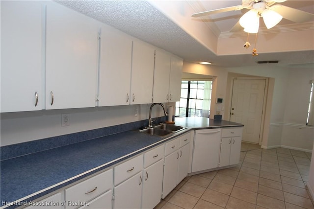 kitchen with white dishwasher, white cabinetry, sink, and light tile patterned floors