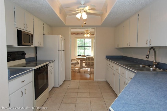 kitchen with white cabinets, white electric range oven, light tile patterned flooring, and sink