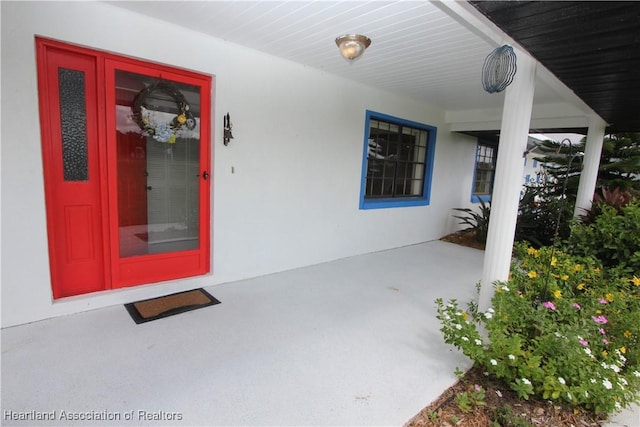 view of exterior entry featuring a porch