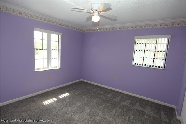 empty room with dark carpet, ceiling fan, and ornamental molding