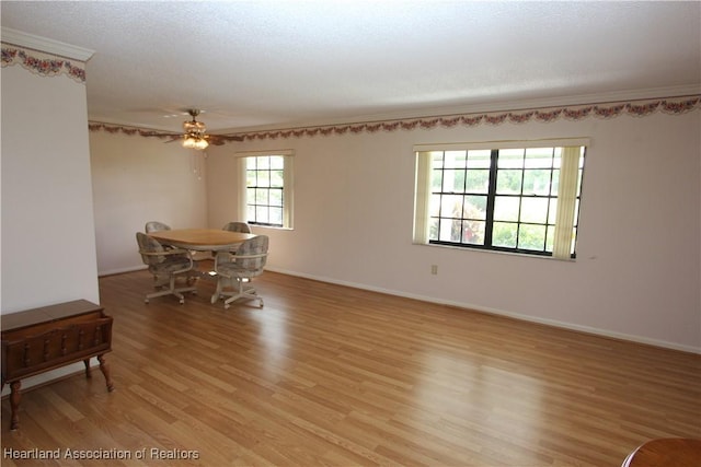 dining area featuring ornamental molding, light hardwood / wood-style floors, ceiling fan, and a healthy amount of sunlight