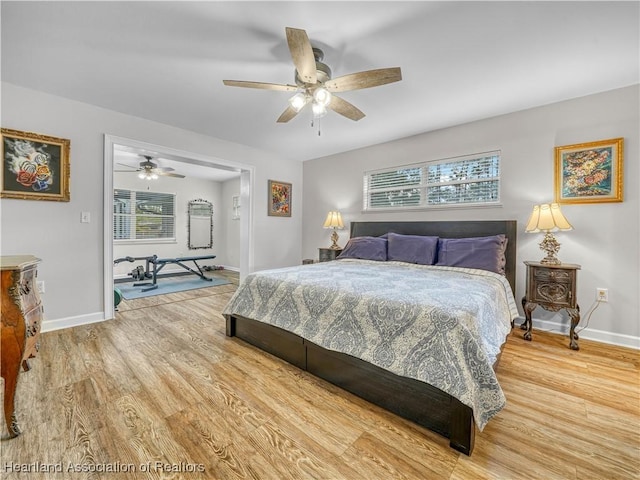 bedroom with a ceiling fan, baseboards, and wood finished floors