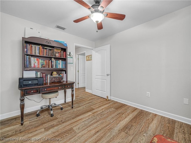 home office with light wood finished floors, baseboards, and visible vents