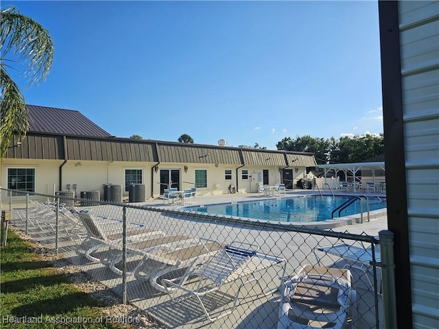 102 Oak St, Lake Placid, FL 33852 - community pool featuring cooling unit, fence, and a patio area