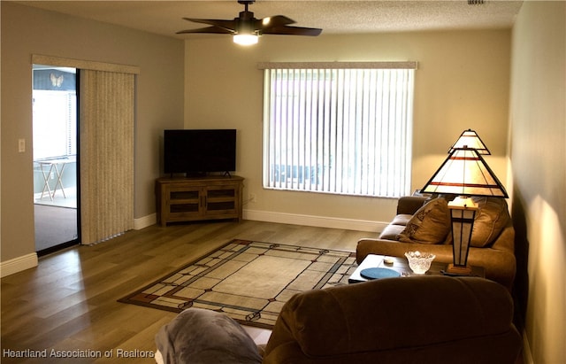 102 Oak St, Lake Placid, FL 33852 - living area with wood finished floors, ceiling fan, and baseboards