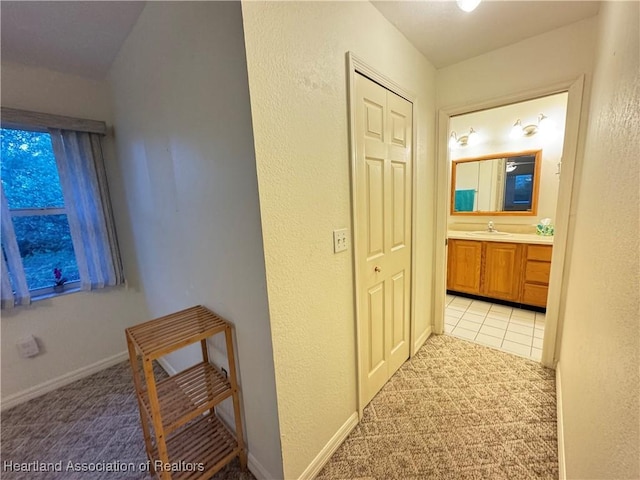 246 Thurman Ave, Lake Placid, FL 33852 - hallway featuring baseboards, a sink, and light carpet