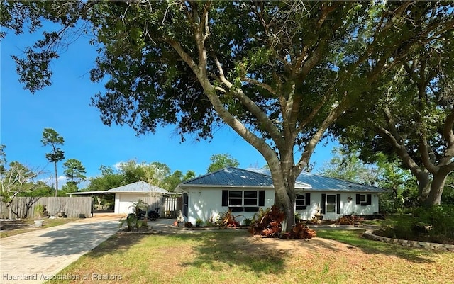 246 Thurman Ave, Lake Placid, FL 33852 - ranch-style home with driveway, a carport, and metal roof