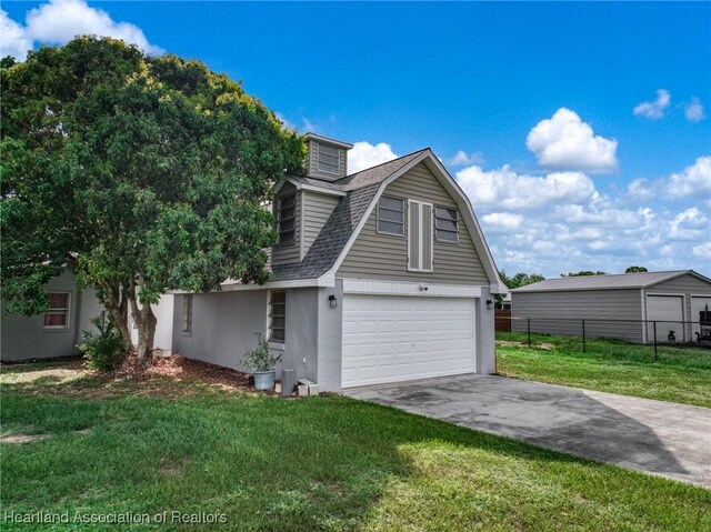 301 Sparrow Ave, Sebring, FL 33870 - view of front of home with an attached garage, stucco siding, a gambrel roof, asphalt driveway, and a shingled roof