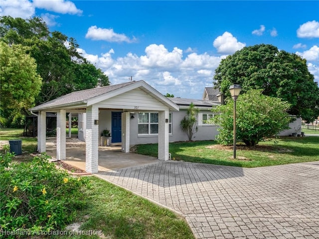 301 Sparrow Ave, Sebring, FL 33870 - single story home with decorative driveway, a front lawn, and an attached carport