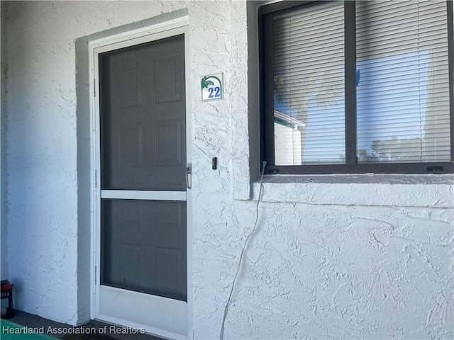 4869 Casablanca Cir Unit G22, Sebring, FL 33870 - doorway to property featuring stucco siding
