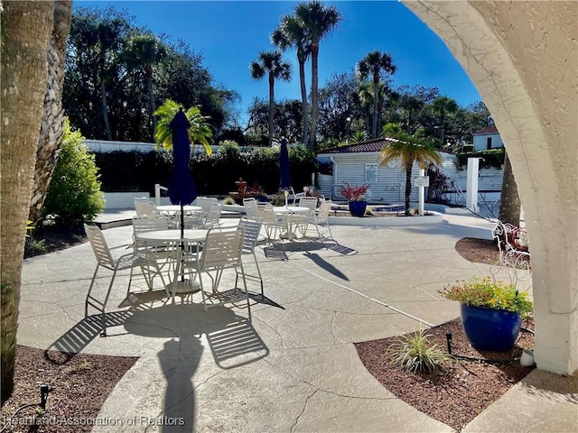 4869 Casablanca Cir Unit G22, Sebring, FL 33870 - view of patio / terrace with outdoor dining space and an outbuilding