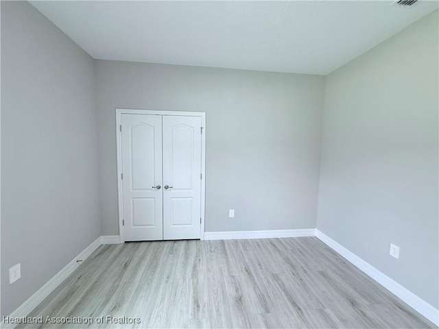 unfurnished room featuring light wood-style floors and baseboards