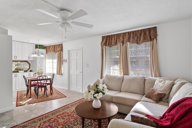 tiled living room with a textured ceiling and ceiling fan