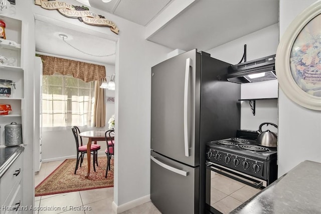 kitchen with black electric range, light tile patterned floors, white cabinets, and stainless steel fridge