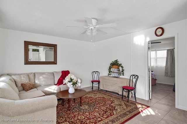 living room with ceiling fan and light tile patterned flooring