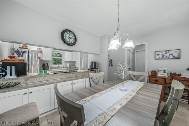 tiled dining space with lofted ceiling