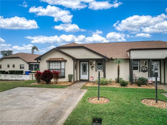 ranch-style home with a front lawn