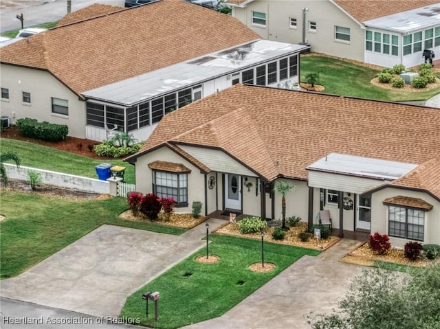 exterior space featuring a sunroom and a front yard