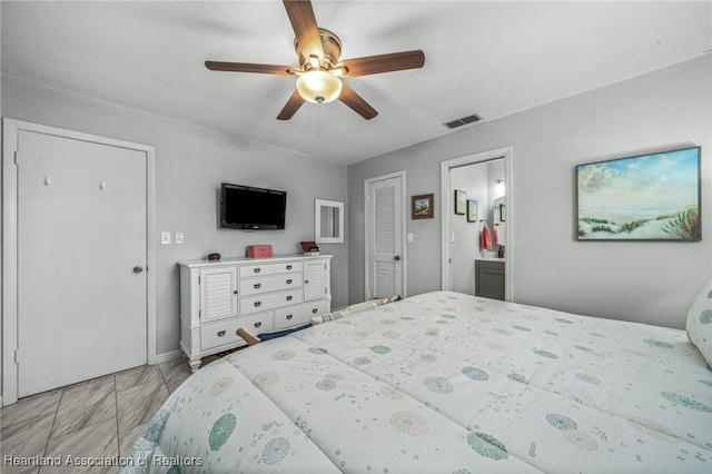 bedroom featuring ceiling fan and ensuite bathroom