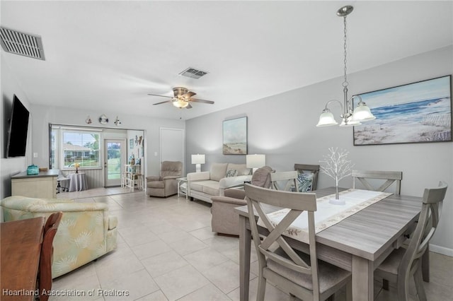 dining area featuring ceiling fan with notable chandelier and light tile patterned floors