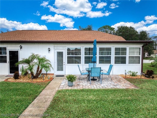 back of house featuring a yard and a patio