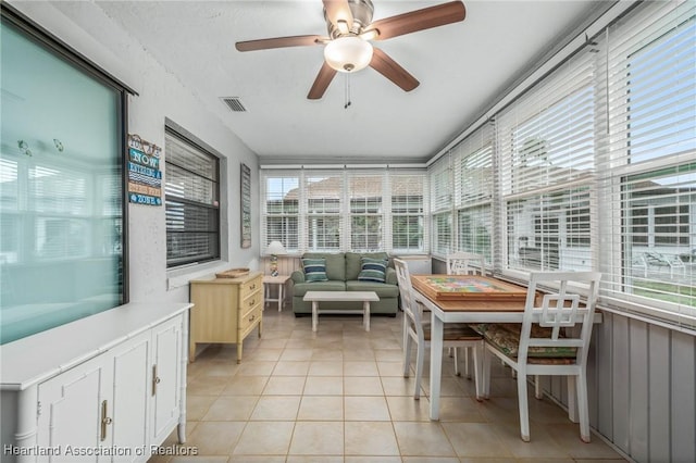 sunroom featuring ceiling fan