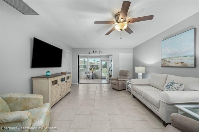 tiled living room with ceiling fan