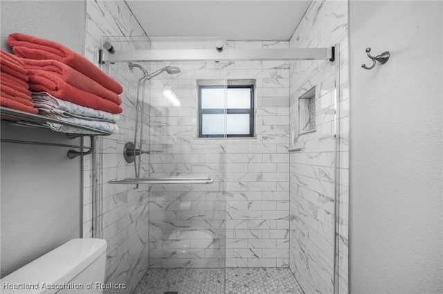 bathroom with an enclosed shower and toilet