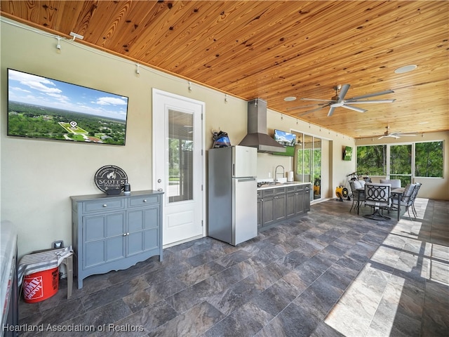 view of patio / terrace featuring ceiling fan, an outdoor kitchen, and sink