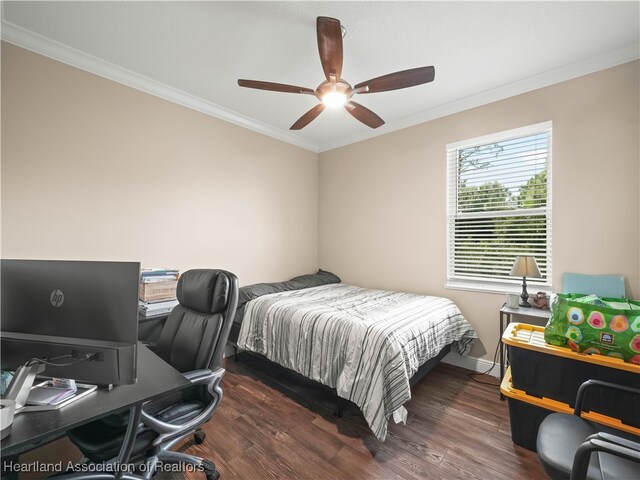 bedroom featuring crown molding, dark wood-type flooring, and ceiling fan