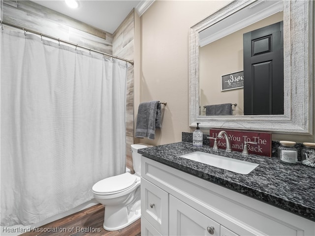 bathroom with vanity, hardwood / wood-style flooring, curtained shower, and toilet