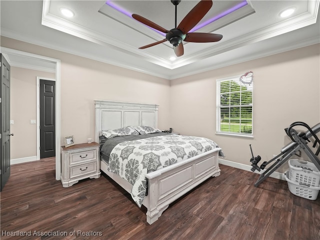 bedroom with a raised ceiling, ornamental molding, dark hardwood / wood-style floors, and ceiling fan