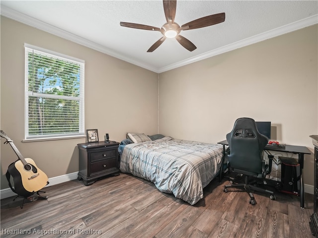 bedroom featuring hardwood / wood-style floors, crown molding, and ceiling fan