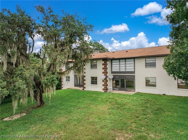 19 A Miracle Ave, Avon Park, FL 33825 - back of property with a yard and stucco siding