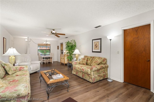 19 A Miracle Ave, Avon Park, FL 33825 - living area featuring wood finished floors, a ceiling fan, a chandelier, and a textured ceiling