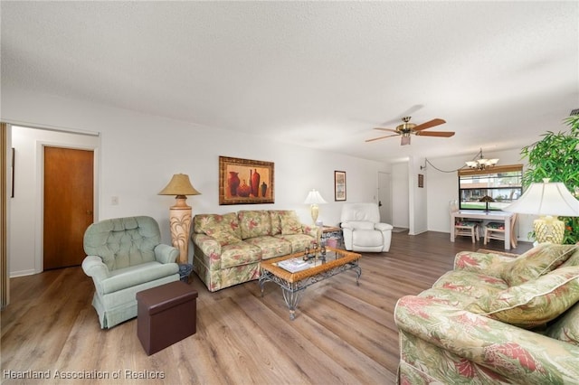 19 A Miracle Ave, Avon Park, FL 33825 - living area with wood finished floors, a ceiling fan, and a chandelier