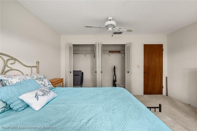 19 A Miracle Ave, Avon Park, FL 33825 - bedroom featuring two closets, carpet flooring, a textured ceiling, and ceiling fan
