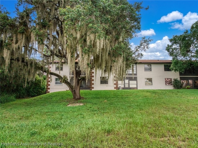 19 A Miracle Ave, Avon Park, FL 33825 - back of property with stucco siding and a yard