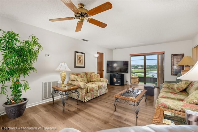 19 A Miracle Ave, Avon Park, FL 33825 - living room with wood finished floors and a ceiling fan