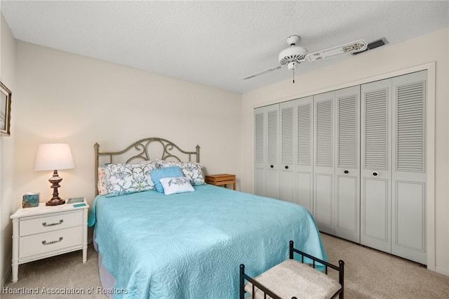 19 A Miracle Ave, Avon Park, FL 33825 - carpeted bedroom with ceiling fan, a closet, and a textured ceiling