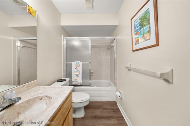 19 A Miracle Ave, Avon Park, FL 33825 - full bath featuring vanity, wood finished floors, and enclosed tub / shower combo