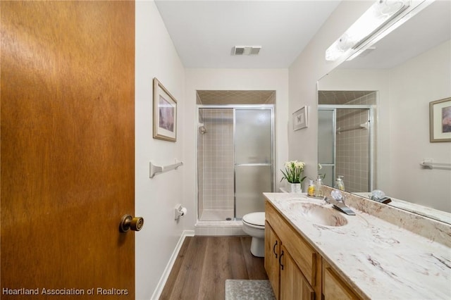 19 A Miracle Ave, Avon Park, FL 33825 - bathroom with vanity, wood finished floors, and a stall shower